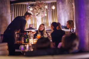 Waiter serving drinks to a table