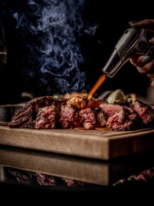 Copy of STK Q 2023 @lateef.photography-9 Picture of steak and accompaniments being seared with a blow torch