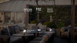 A cozy seating area at a One Group restaurant. Logos for 'Radio', 'By Melia', 'Heliot Steak House', 'Hippodrome Casino', 'W Hotels' and 'the Cosmopolitan of Las Vegas' embedded over image.